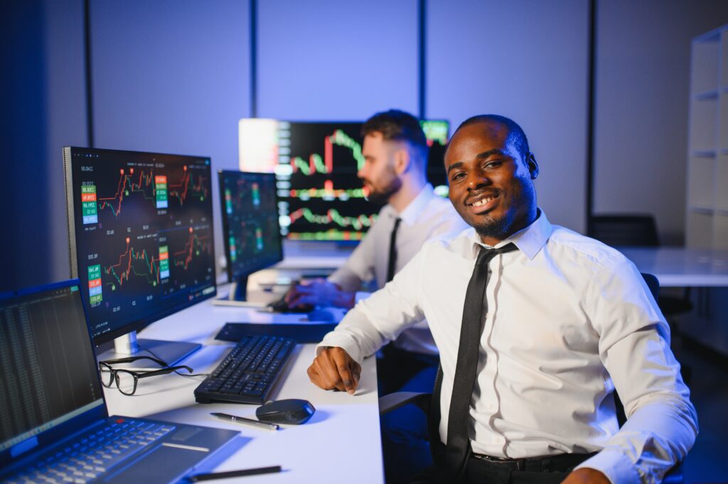 conception of teamwork. team of stockbrokers works in modern office with many display screens